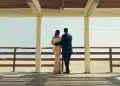 man and woman standing on wooden dock during daytime