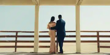 man and woman standing on wooden dock during daytime