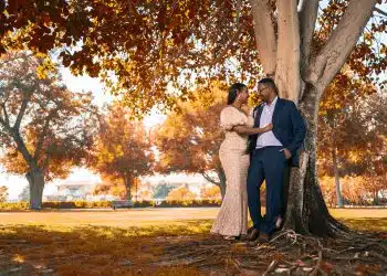 couple kissing under brown tree during daytime