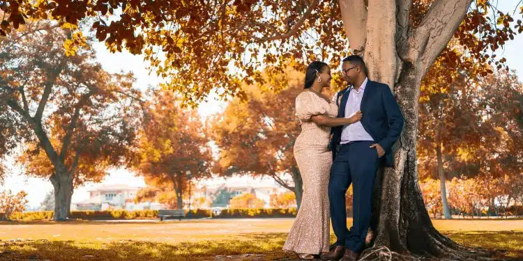 couple kissing under brown tree during daytime